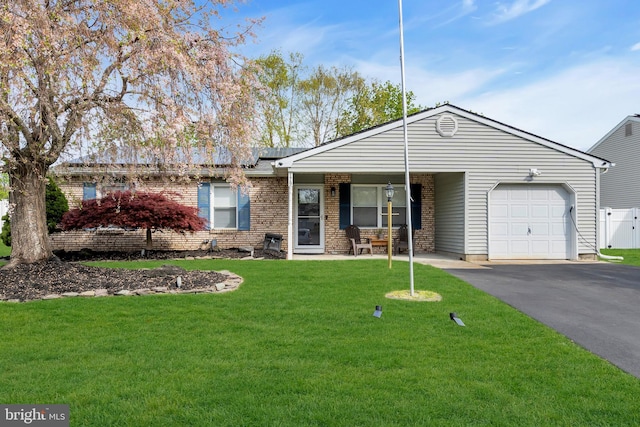 179 Ravenwood Blvd, Barnegat, NJ 08005 - ranch-style house with a garage, driveway, a front yard, and brick siding