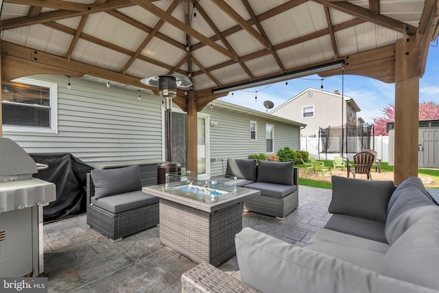 179 Ravenwood Blvd, Barnegat, NJ 08005 - view of patio featuring an outdoor living space with a fire pit, a trampoline, a gazebo, fence, and a grill