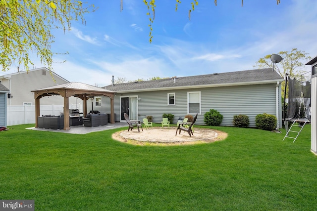 179 Ravenwood Blvd, Barnegat, NJ 08005 - back of property with an outdoor hangout area, a trampoline, a gazebo, and a patio area