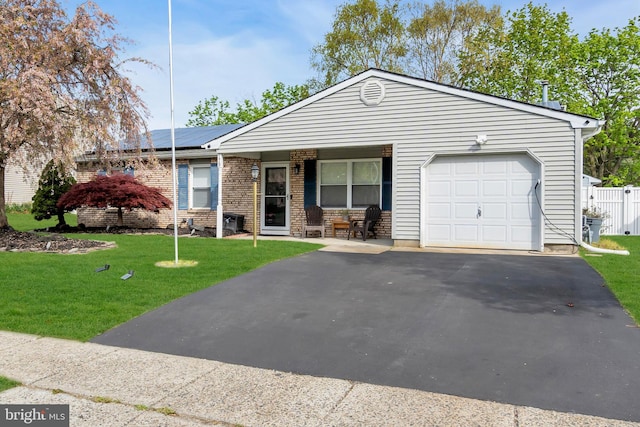 179 Ravenwood Blvd, Barnegat, NJ 08005 - ranch-style home featuring an attached garage, roof mounted solar panels, asphalt driveway, and covered porch