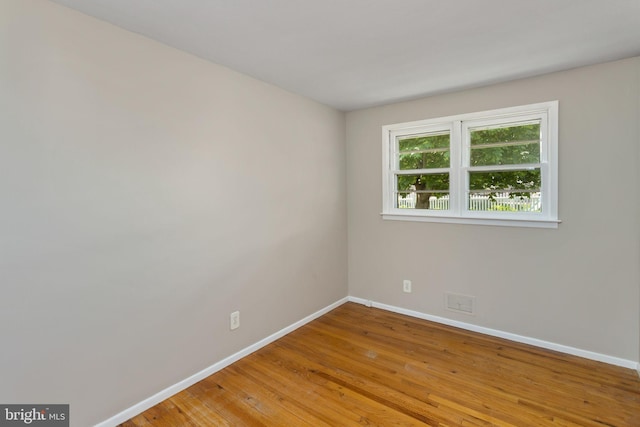 empty room with baseboards and light wood finished floors