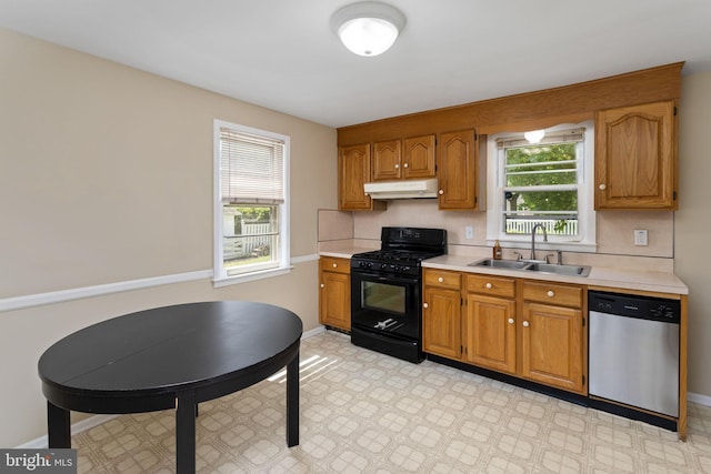 kitchen featuring stainless steel dishwasher, black range with gas cooktop, under cabinet range hood, a sink, and light countertops