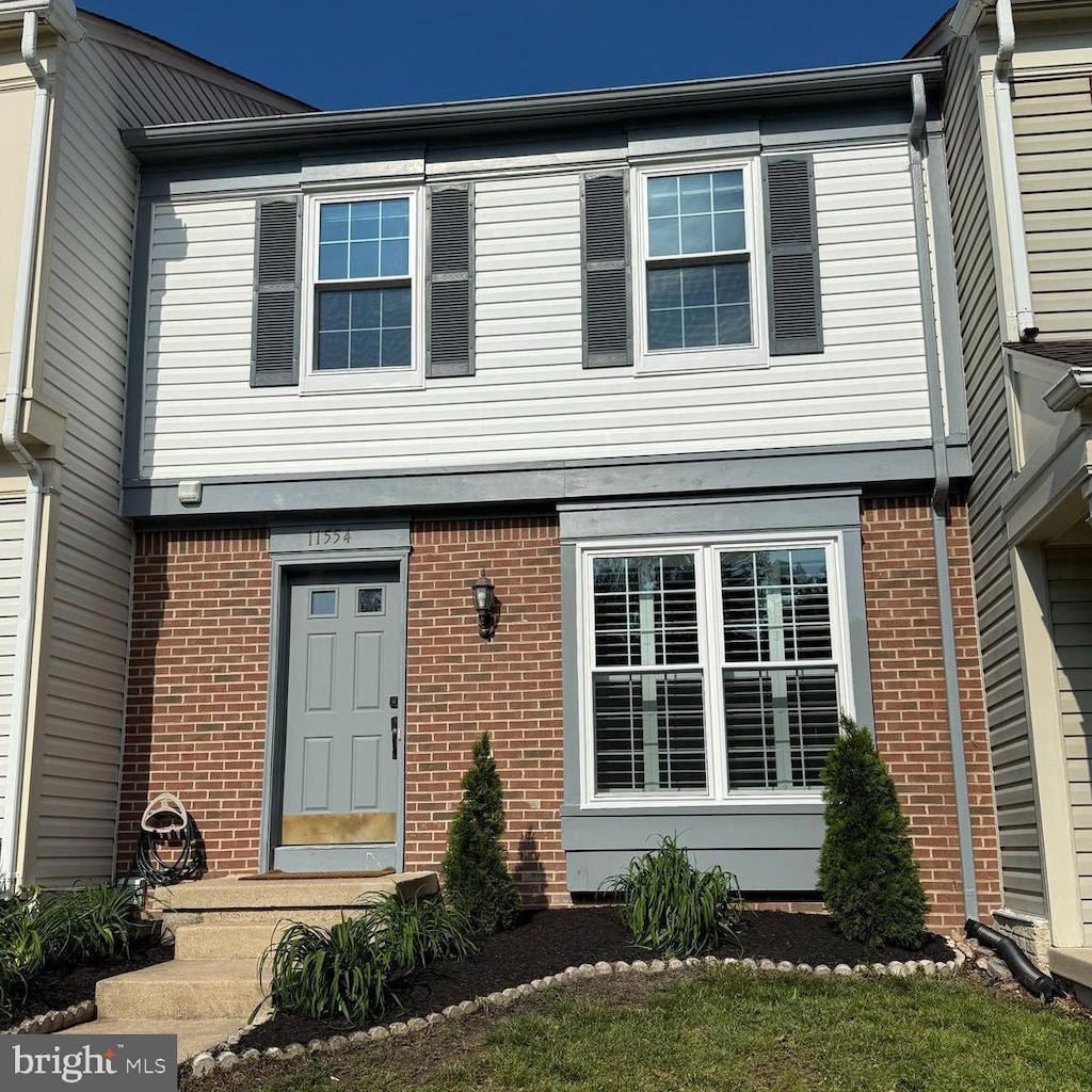 townhome / multi-family property featuring brick siding