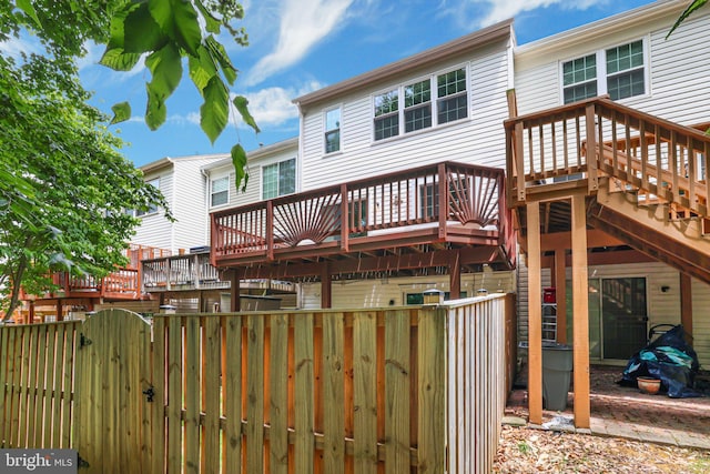 11554 Bertram St, Woodbridge, VA 22192 - back of house featuring a wooden deck, fence, and a gate
