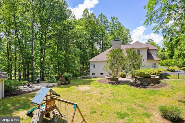 view of yard with a playground and a patio