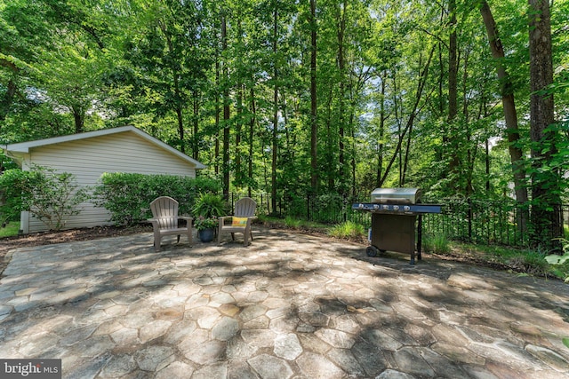 view of patio with a grill and fence