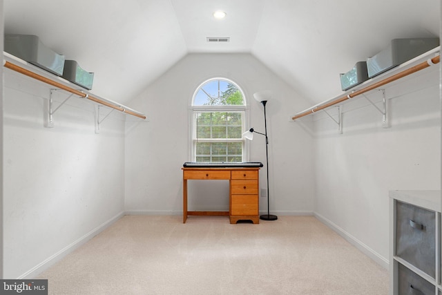 spacious closet featuring light carpet and lofted ceiling