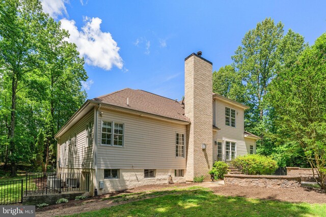back of property featuring a chimney