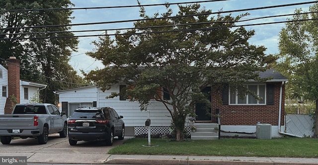 view of front of property with brick siding and cooling unit