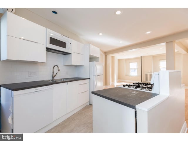 1539 E Berks St, Philadelphia, PA 19125 - kitchen featuring white appliances, white cabinets, modern cabinets, dark countertops, and recessed lighting