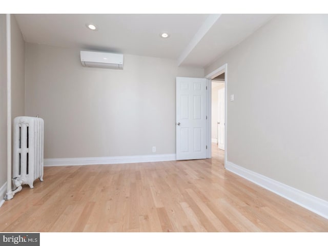 1539 E Berks St, Philadelphia, PA 19125 - empty room with radiator, a wall mounted air conditioner, light wood-style floors, baseboards, and recessed lighting