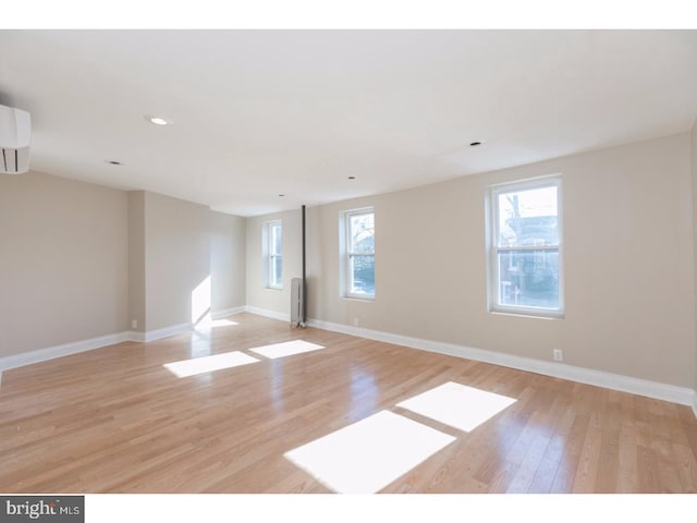 1539 E Berks St, Philadelphia, PA 19125 - unfurnished room featuring light wood-style flooring, baseboards, recessed lighting, a wall mounted AC, and radiator