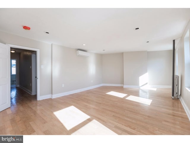 1539 E Berks St, Philadelphia, PA 19125 - empty room featuring an AC wall unit, light wood-style floors, baseboards, and recessed lighting