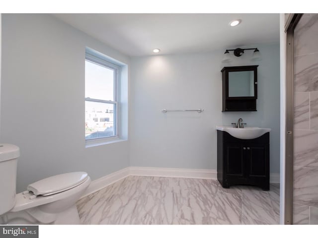 1539 E Berks St, Philadelphia, PA 19125 - bathroom with marble look tile flooring, toilet, vanity, recessed lighting, and baseboards