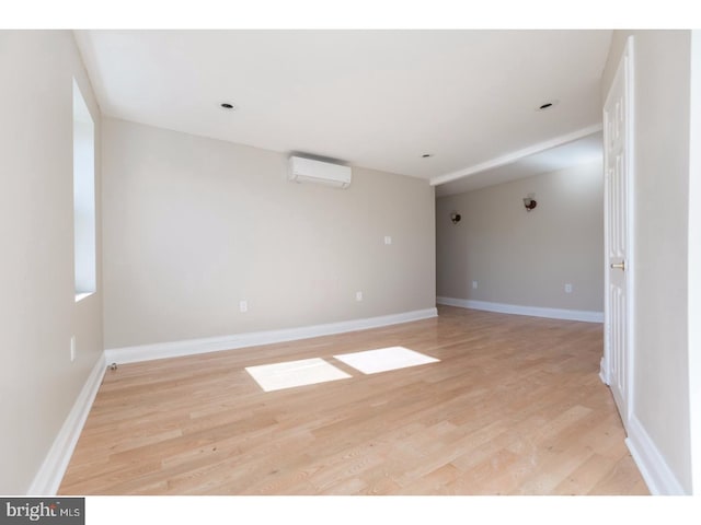1539 E Berks St, Philadelphia, PA 19125 - unfurnished room featuring an AC wall unit, light wood-style flooring, and baseboards