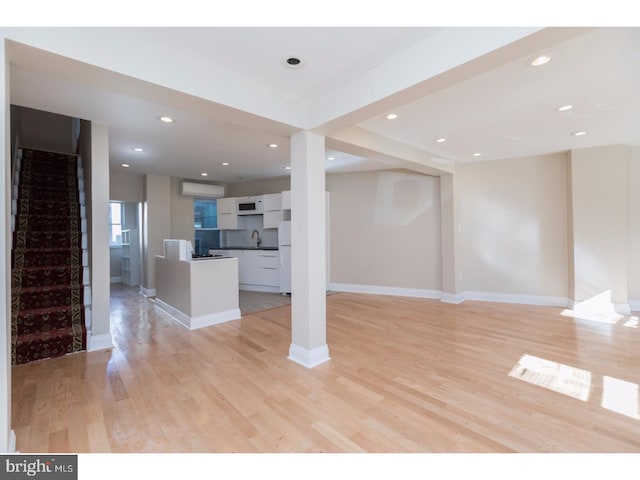 1539 E Berks St, Philadelphia, PA 19125 - unfurnished living room featuring stairway, light wood finished floors, recessed lighting, a sink, and baseboards