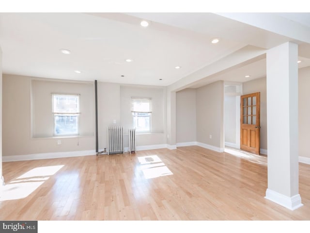 1539 E Berks St, Philadelphia, PA 19125 - unfurnished living room with radiator, light wood-style floors, baseboards, and recessed lighting