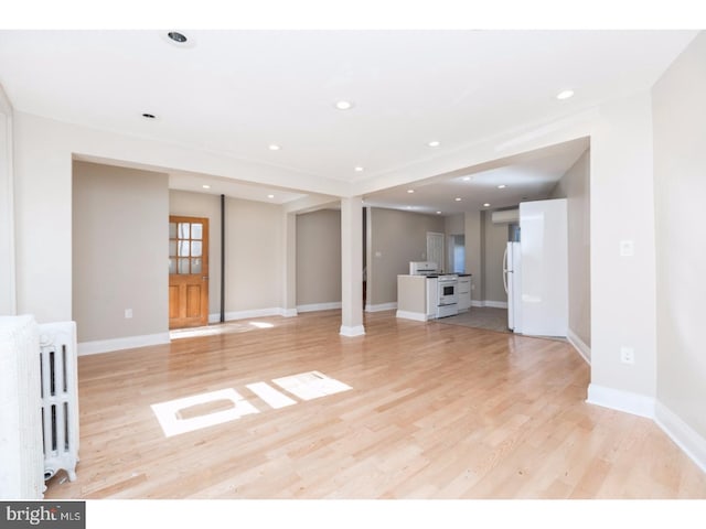 1539 E Berks St, Philadelphia, PA 19125 - unfurnished living room featuring radiator, light wood-type flooring, baseboards, and recessed lighting