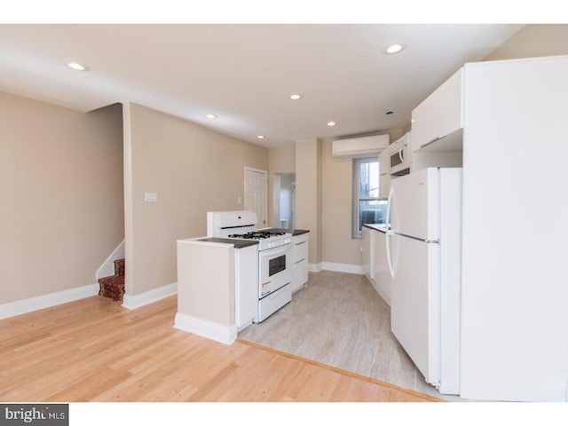 1539 E Berks St, Philadelphia, PA 19125 - kitchen featuring white appliances, white cabinets, light wood-style floors, baseboards, and recessed lighting