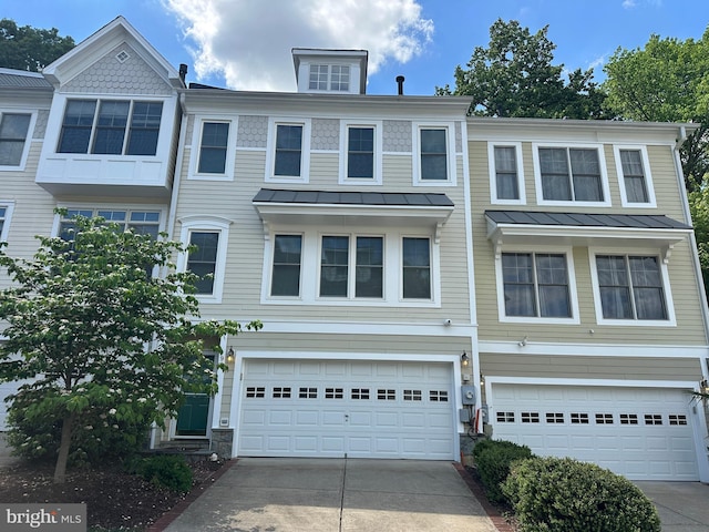 93 Heron Ln, Occoquan, VA 22125 - townhome / multi-family property featuring a standing seam roof, concrete driveway, a garage, and metal roof