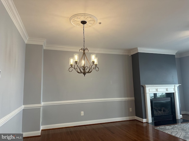 93 Heron Ln, Occoquan, VA 22125 - unfurnished dining area featuring wood finished floors, crown molding, a chandelier, baseboards, and a fireplace with flush hearth