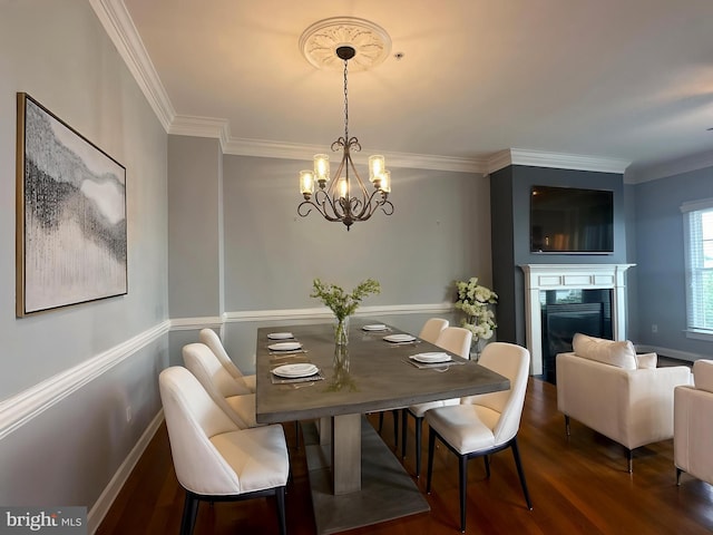 93 Heron Ln, Occoquan, VA 22125 - dining room with wood finished floors, a chandelier, ornamental molding, a fireplace, and baseboards