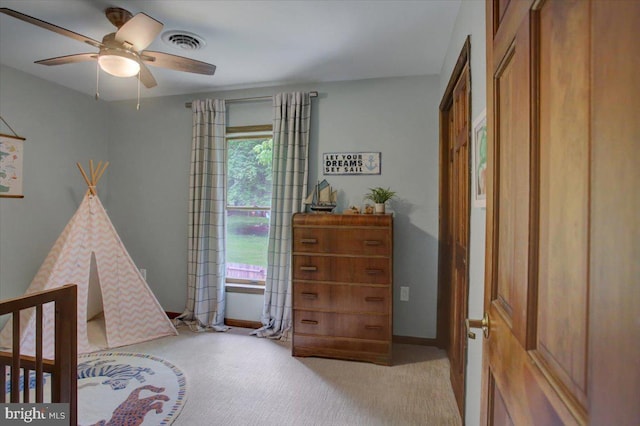 carpeted bedroom featuring baseboards and a ceiling fan