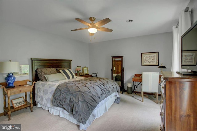 bedroom featuring light carpet and ceiling fan