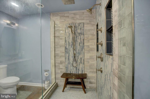 bathroom with a shower stall and toilet