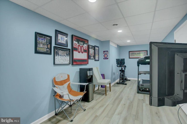 exercise room featuring a drop ceiling, baseboards, wood finished floors, and recessed lighting