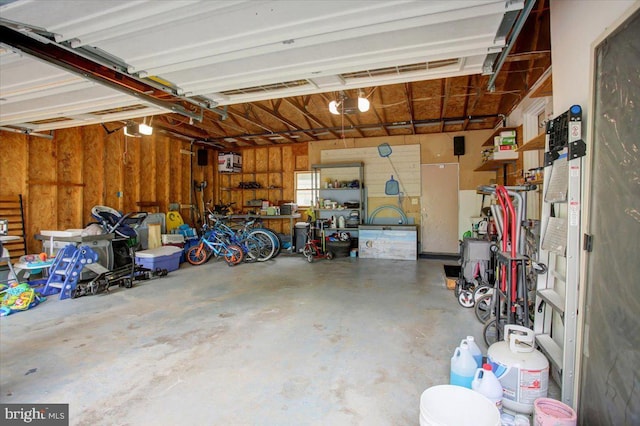 garage featuring a garage door opener and a workshop area