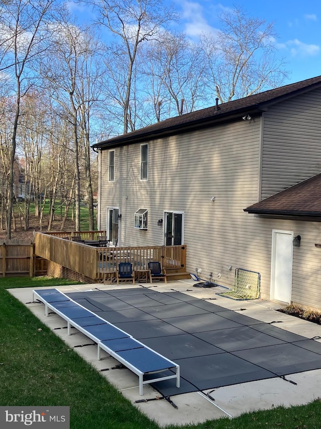 view of swimming pool featuring a deck and fence