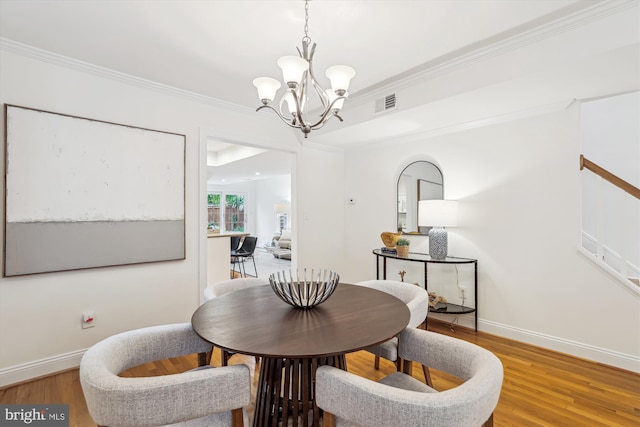 104 E Oxford Ave, Alexandria, VA 22301 - dining room featuring a chandelier, baseboards, wood finished floors, and crown molding