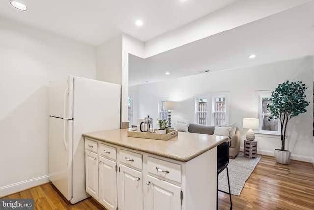 104 E Oxford Ave, Alexandria, VA 22301 - kitchen featuring freestanding refrigerator, light wood finished floors, white cabinetry, recessed lighting, and baseboards