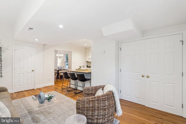 104 E Oxford Ave, Alexandria, VA 22301 - living area with light wood-type flooring, recessed lighting, a chandelier, and baseboards