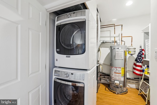 104 E Oxford Ave, Alexandria, VA 22301 - laundry room with water heater, stacked washer / dryer, and wood finished floors
