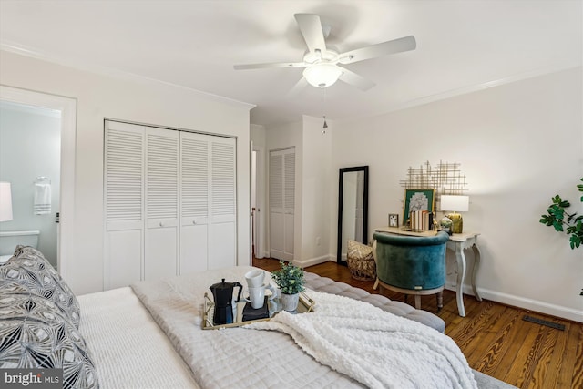 104 E Oxford Ave, Alexandria, VA 22301 - bedroom with wood finished floors, ornamental molding, baseboards, ceiling fan, and two closets