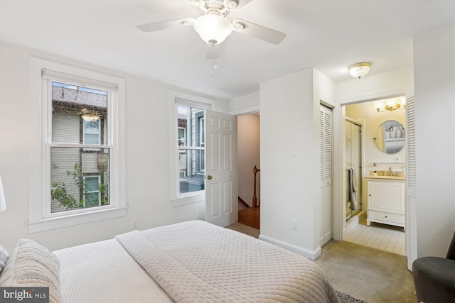 104 E Oxford Ave, Alexandria, VA 22301 - bedroom featuring a sink, light carpet, ensuite bath, and baseboards