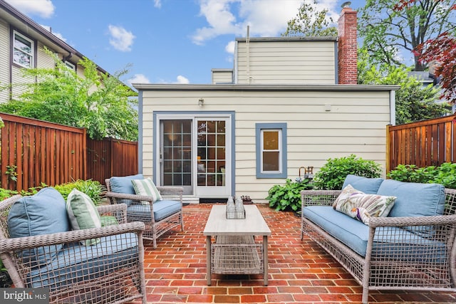 104 E Oxford Ave, Alexandria, VA 22301 - back of house featuring an outdoor living space, a patio area, a fenced backyard, and a chimney