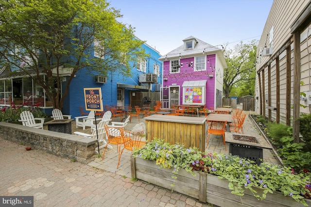 104 E Oxford Ave, Alexandria, VA 22301 - back of property featuring a fire pit, a patio, and an AC wall unit