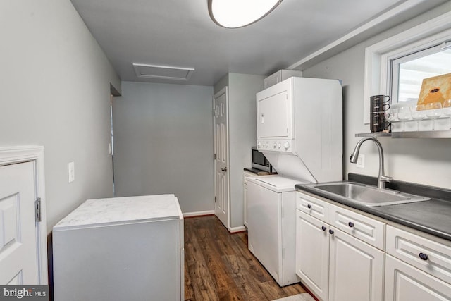 1811 Halifax Rd, Woodbridge, VA 22191 - washroom featuring estacked washer and dryer, a sink, attic access, dark wood finished floors, and baseboards