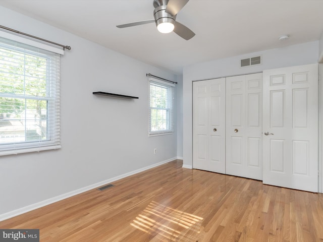 unfurnished bedroom with light wood finished floors, baseboards, a closet, and ceiling fan