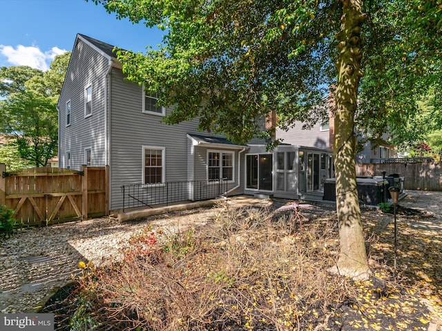 back of house with a sunroom and fence