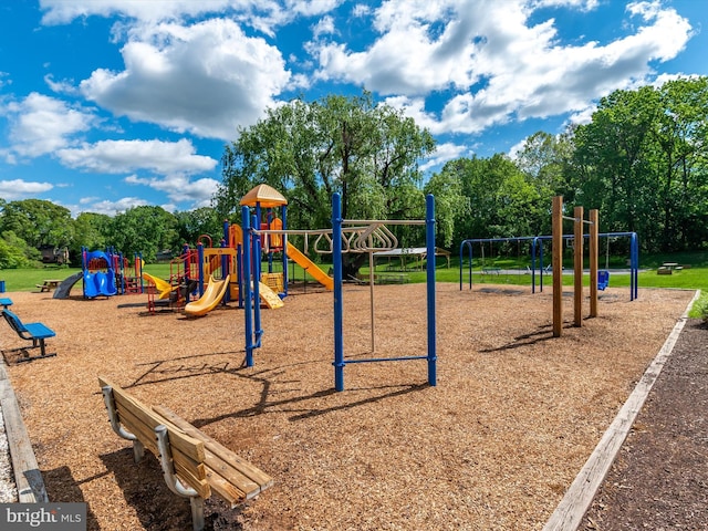 community jungle gym with view of wooded area