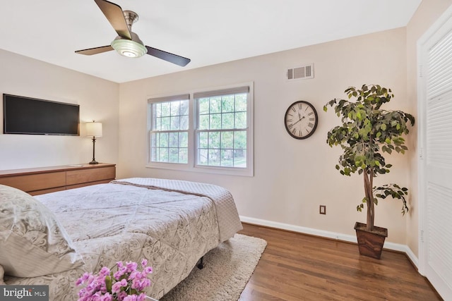 bedroom with wood finished floors, baseboards, and ceiling fan