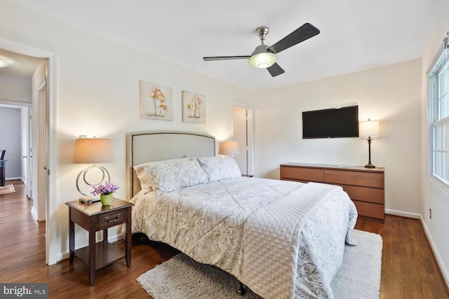 bedroom with wood finished floors, baseboards, and ceiling fan