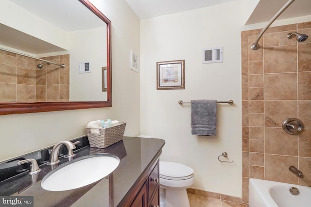 bathroom with tile patterned flooring, vanity, shower / tub combination, and toilet