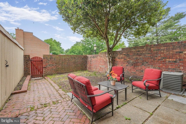 view of patio / terrace featuring central AC unit, a gate, and a fenced backyard