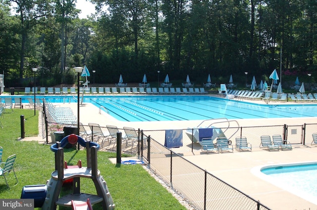 community pool featuring view of scattered trees
