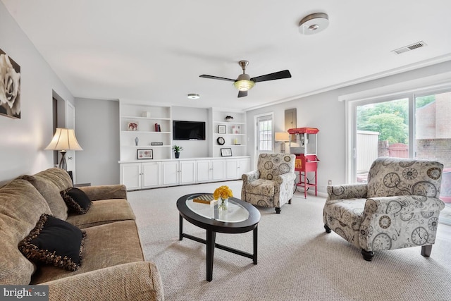 carpeted living room with healthy amount of natural light and ceiling fan